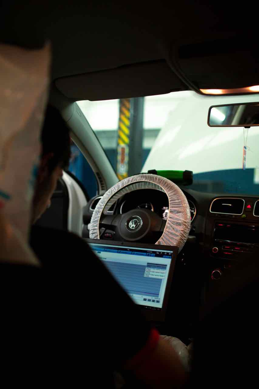 Mechanic running a computer diagnostic scan on a vehicle